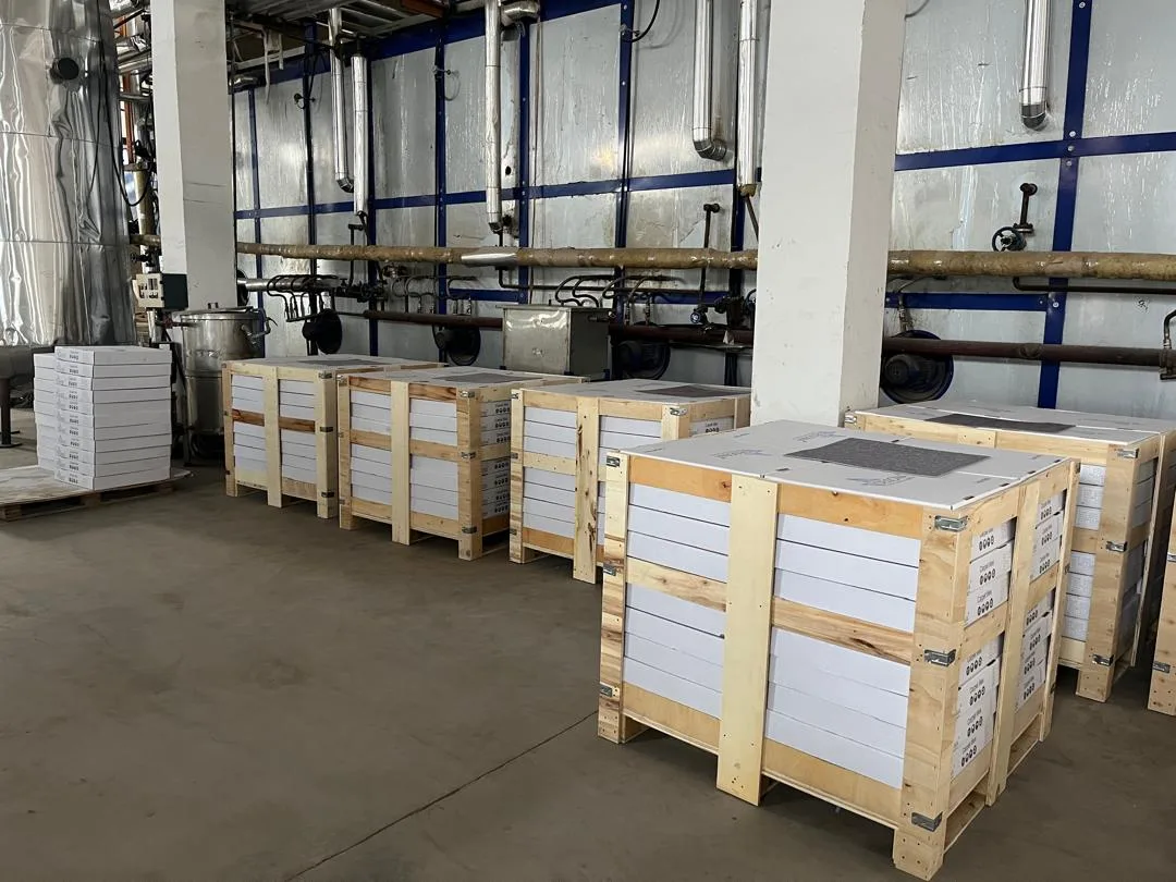 Wooden crates of boxed flocked carpet tile on pallets in the factory warehouse