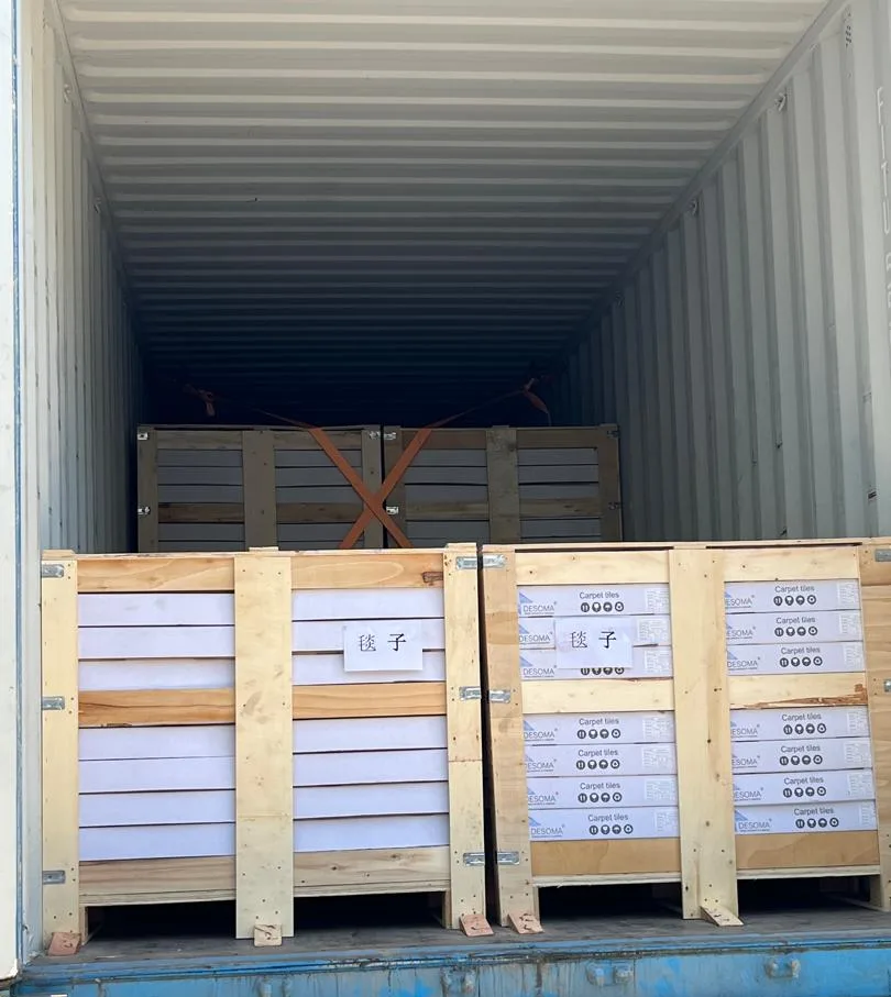 Wooden crates of flocked carpet tile loaded inside a shipping container